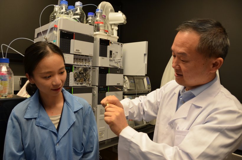 Jian Yang with Ph.D. student Chuying Ma displaying a bendable citrate-based...