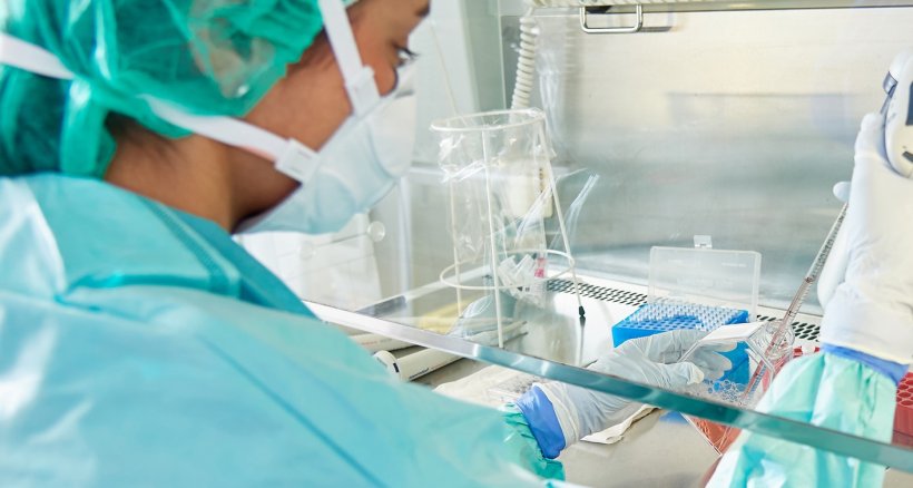 medical scientist in a laboratory handling liquid samples