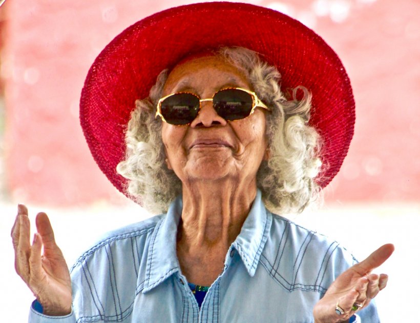 elderly woman with sunglasses and red hat