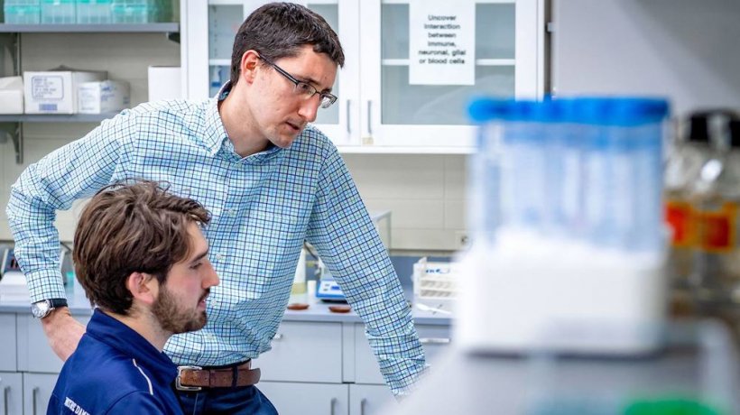 Cody Smith chats with a graduate student in his lab.