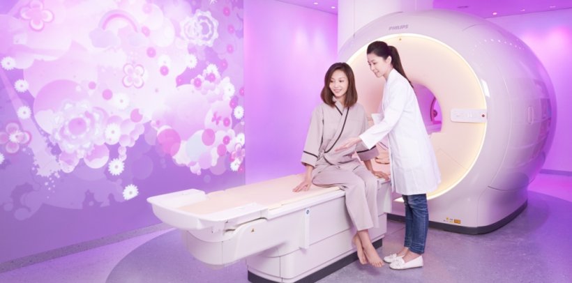 two asian women using mri device with flowery ambient design