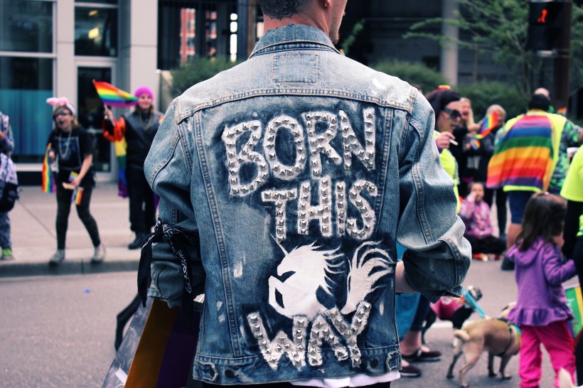 person wearing denim jacket at gay pride festival