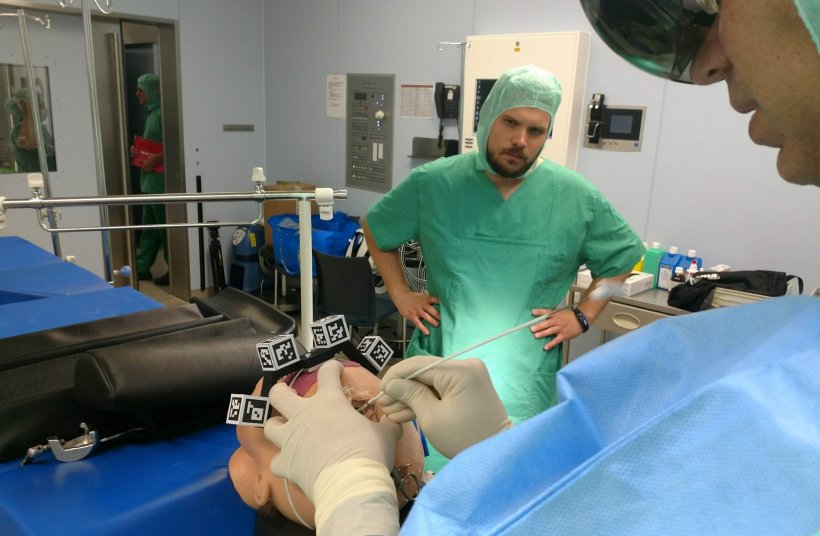 surgeon with hololens augmented reality glasses training on phantom