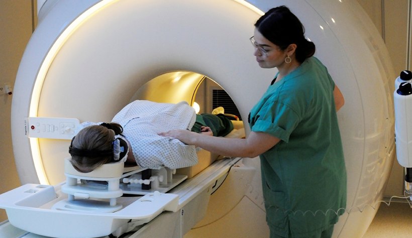 woman undergoing examination in MRI scanner