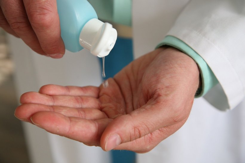person applying hand disinfectant
