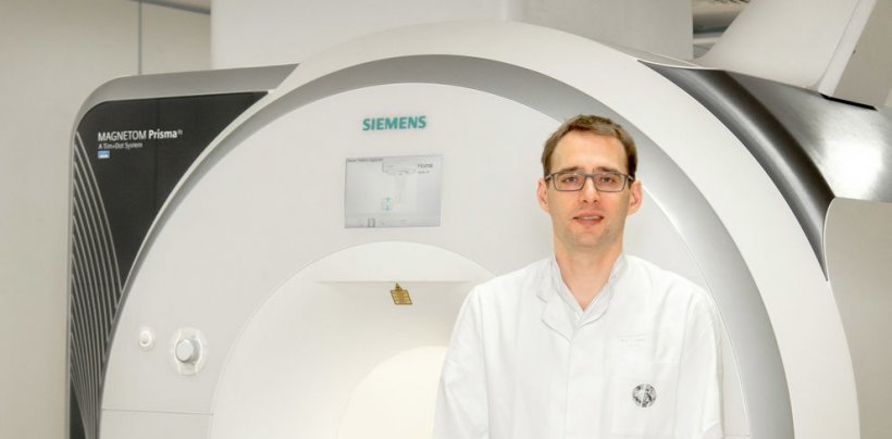 radiologists standing in front of MRI scanner