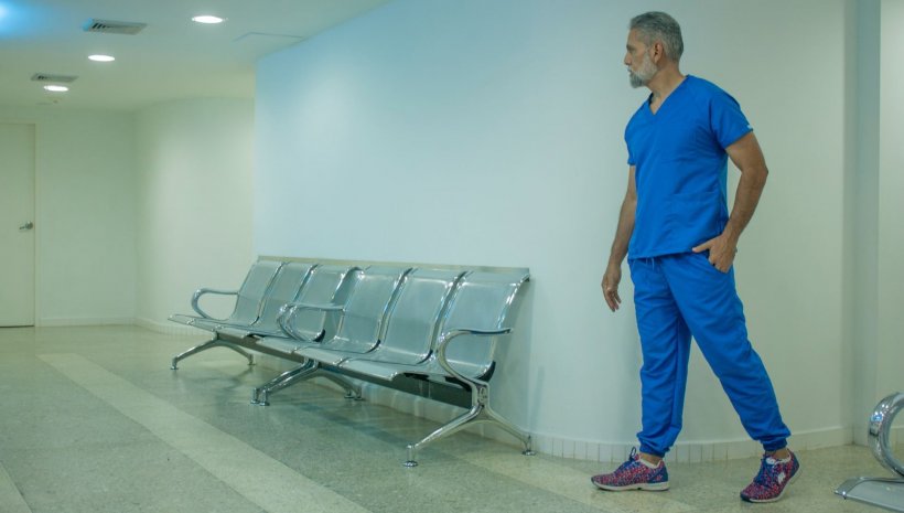 man in blue clothes checking empty waiting room