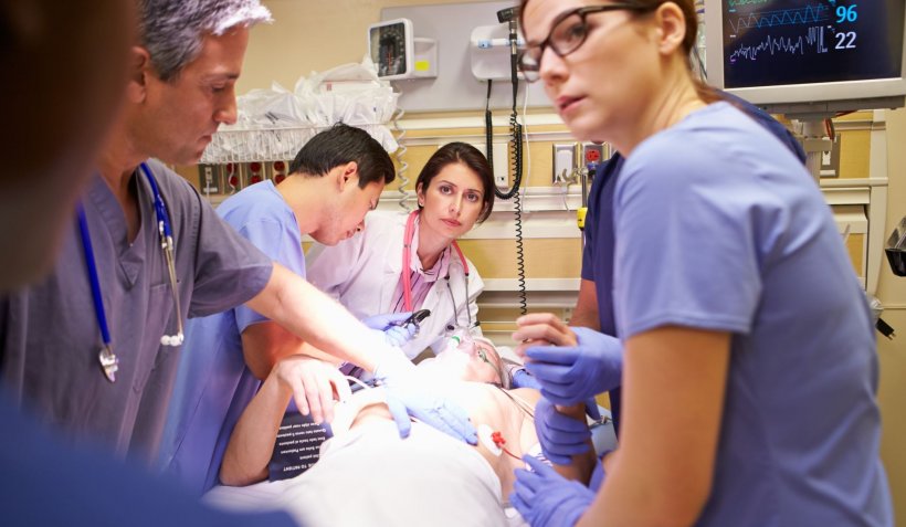 Medical Team Working On Patient In Emergency Room