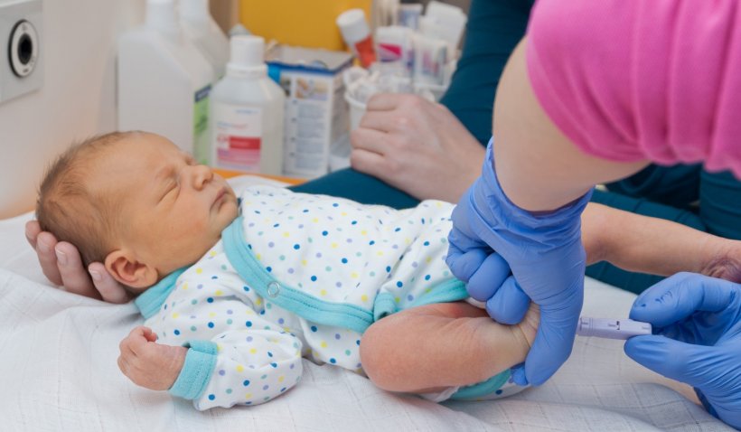 medical screening examination on newborn baby