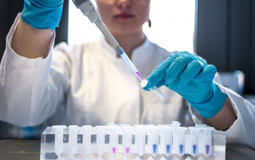 female scientist performing test with pipette in laboratory setting