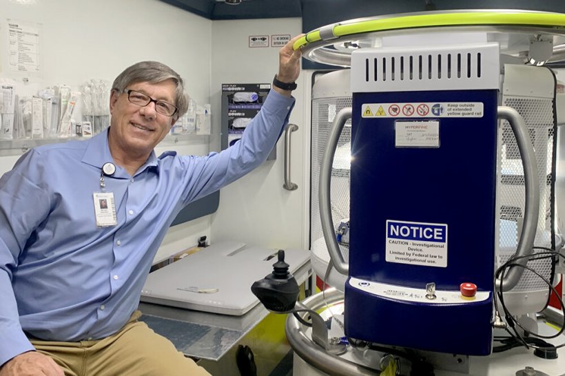 Michael Haschker, manager of telehealth technologies, posing in the back of an...