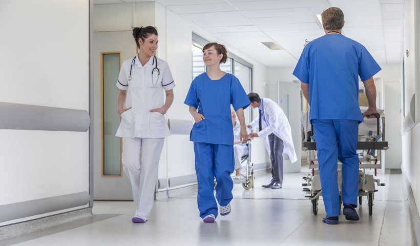 doctor and nurse walking in hospital corridor