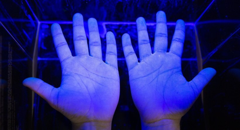 hands under black light