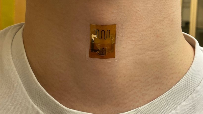 A biofilm-powered sensor, on the neck, that measures the mechanical signal of...
