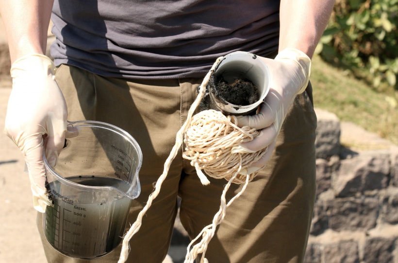 Christian Baars carries water and sediment of a sample taken from a sewer. This...