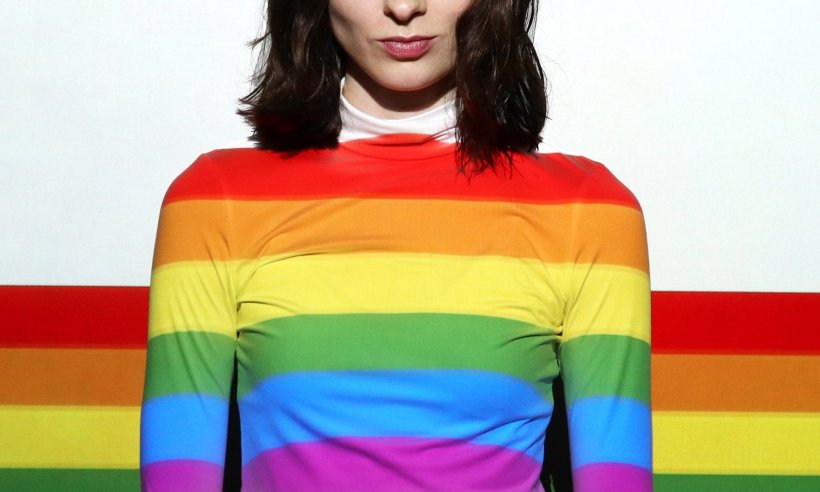 woman wearing rainbow-colored sweatshirt as symbol for LGBTQ pride
