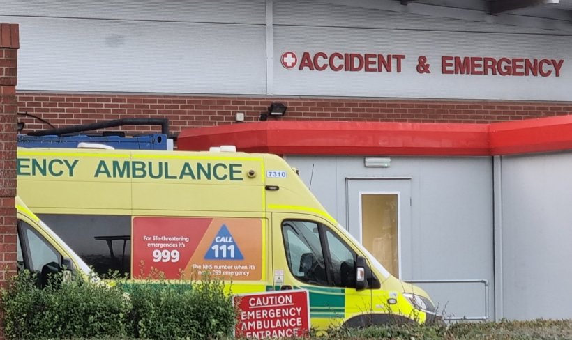uk ambulance waiting in front of hospital a&e department