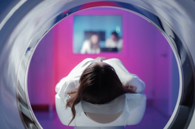 young girl lying in ct scanner for medical examination