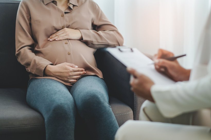 pregnant woman seeing GP doctor for examination