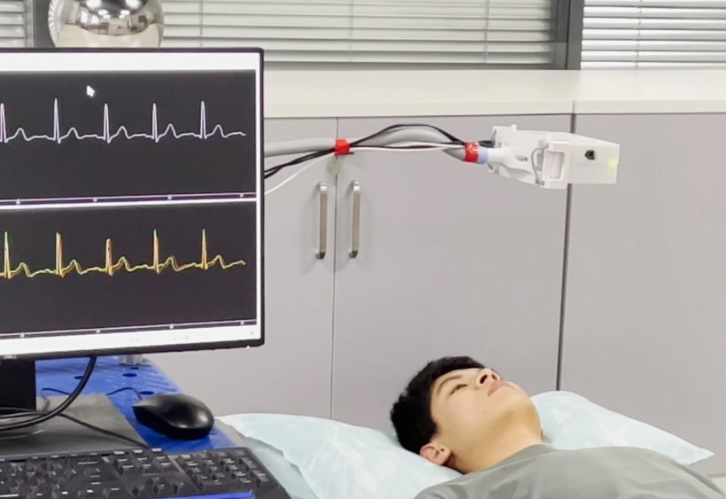 Researchers conducting contactless ECG monitoring experiments