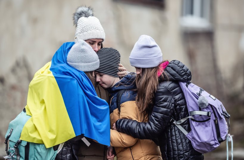 woman in ukraine holding her three children