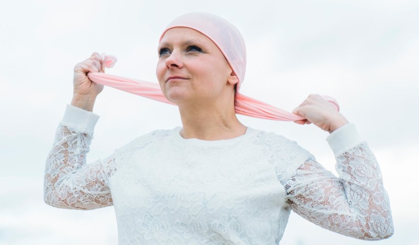 woman with breast cancer wearing pink headscarf