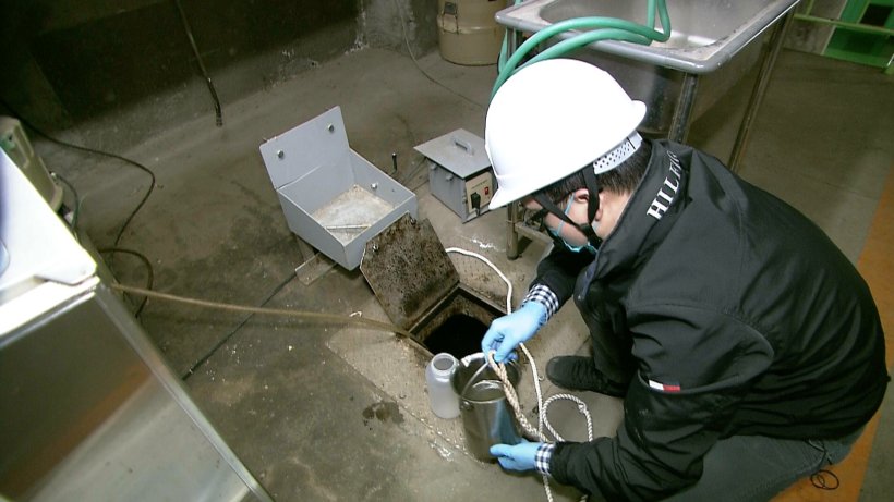 japanese sewage worker wearing white helmet
