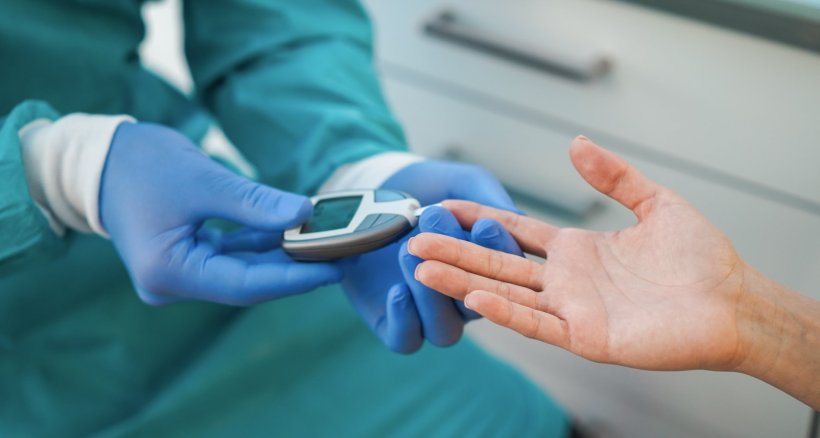 doctor checking blood sugar level of young Diabetes patient