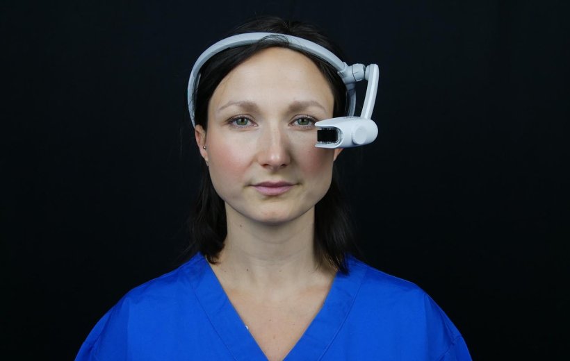woman in blue medical garb wearing smart glasses