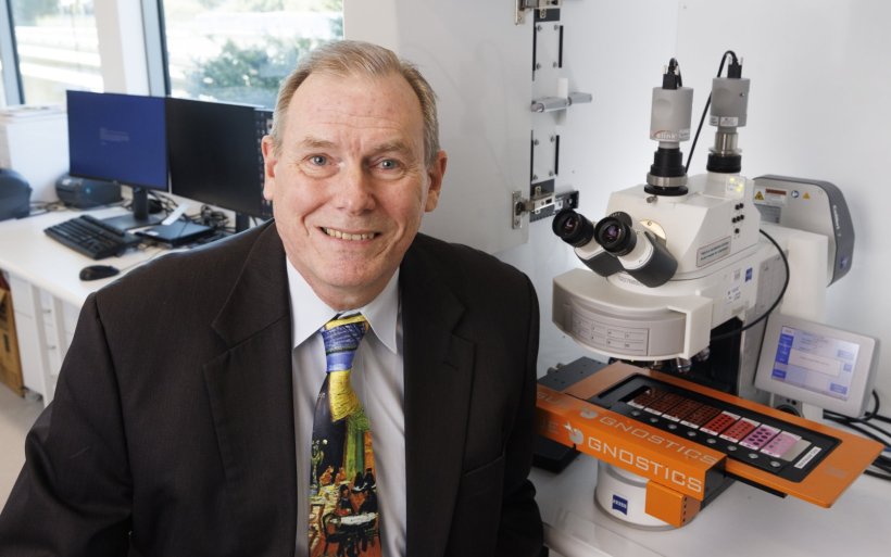 Professor Brian Lovell with a digital microscope scanner