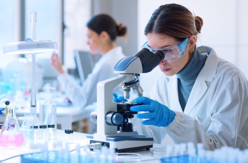 female laboratory experts using microscope