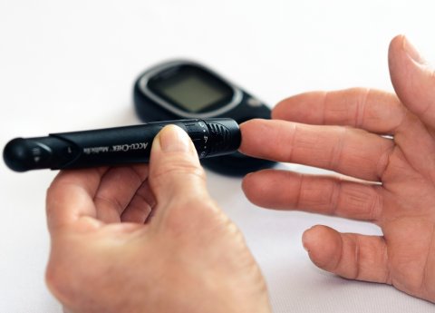 hands of a person performing a blood sugar test for diabetes