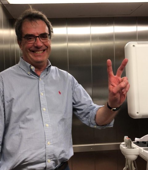 portrait of etienne danse gesturing the 'victory' symbol