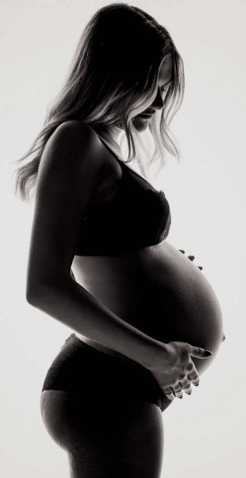 pregnant woman holding her belly