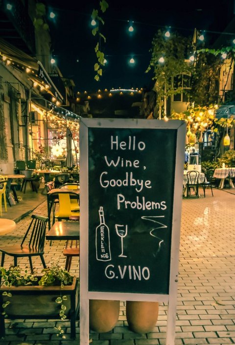 chalkboard sign in front of wine restaurant