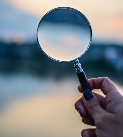magnifying glass in front of blurry landscape