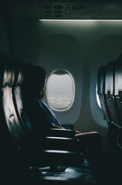 woman sitting next to airplane window
