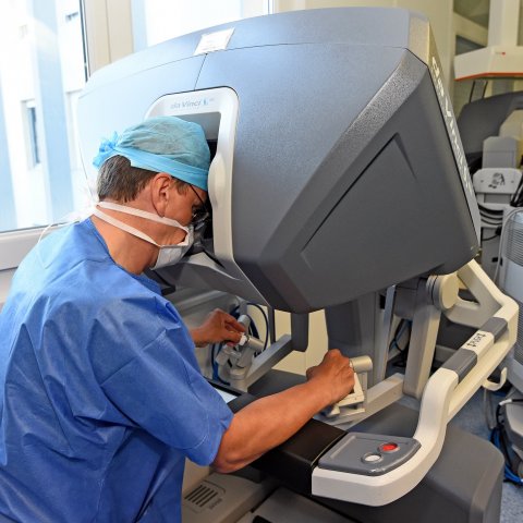 surgeon operating a surgical robot