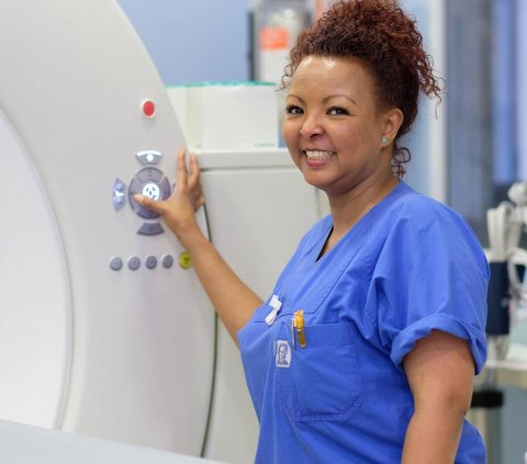 woman operating MRI scanner