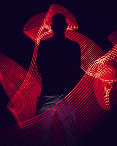 silhouette of man in moving red light