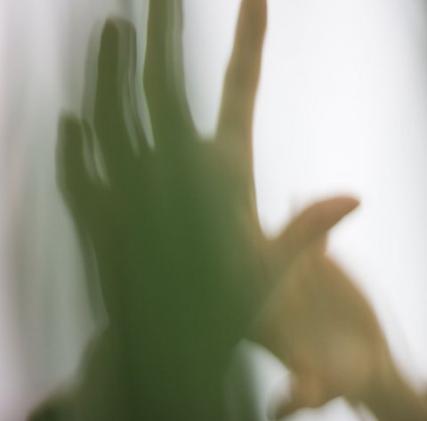 blurred photo of a person's left hand