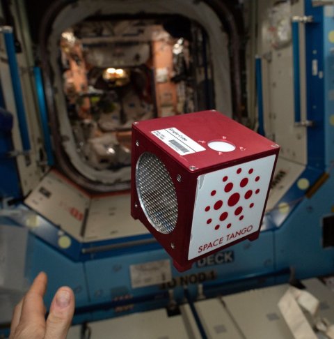 red cube floating in zero-gravity in international space station ISS