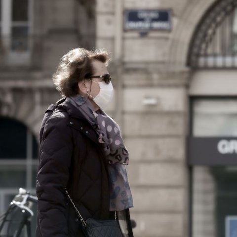 woman wearing protective face mask and sunglasses in france