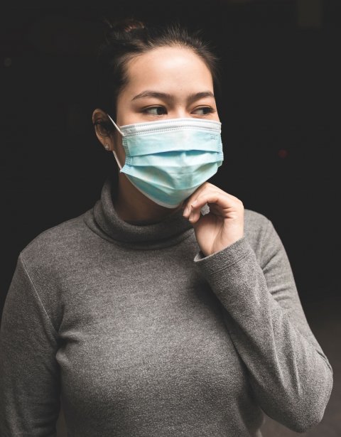 asian woman wearing teal face mask