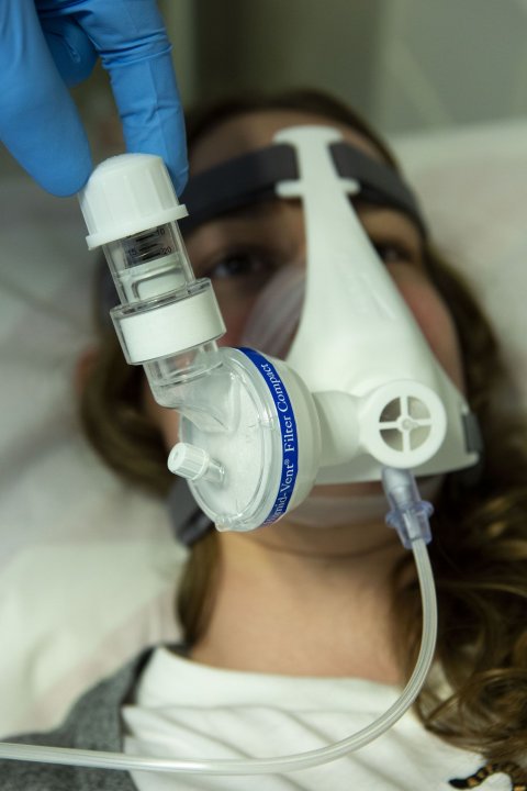 female patient wearing non-invasive respiratory NIP mask