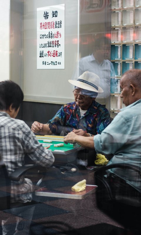 three men playing mahjongg