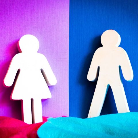 man and woman figure cutout on pink and blue background