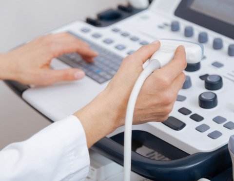 sonographer using ultrasound machine