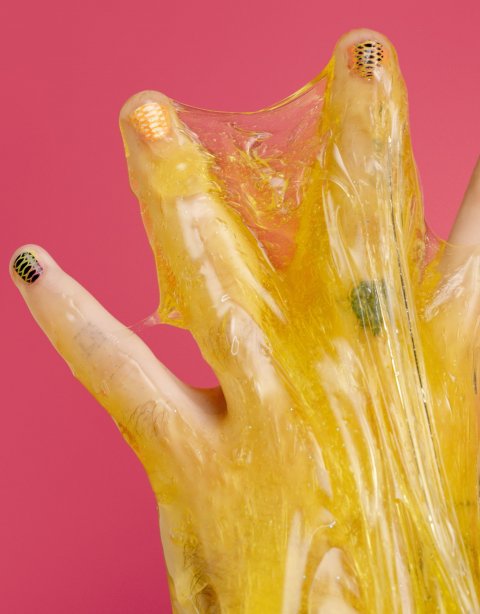 hand covered in yellow slime