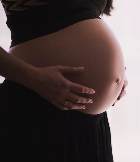pregnant woman holding her belly
